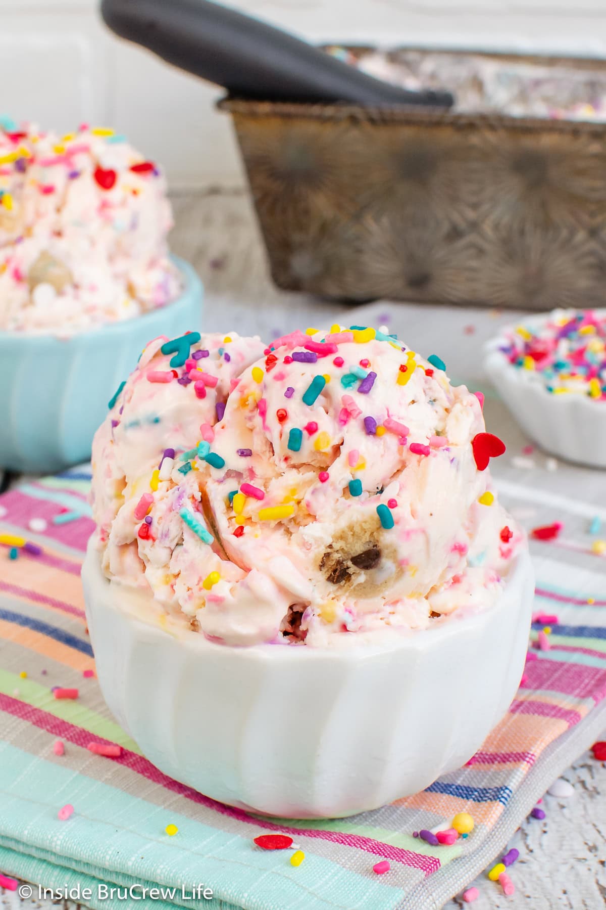 A white bowl filled with no churn confetti ice cream.