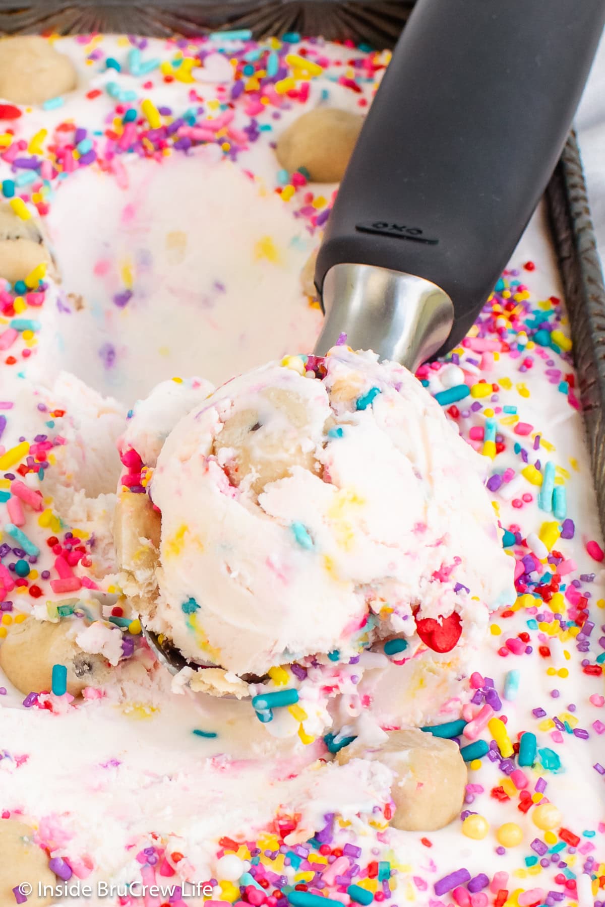 An ice cream scoop of no churn confetti ice cream.