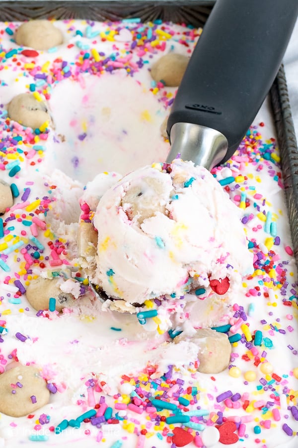 A scoop of ice cream sitting on top of a pan of ice cream.