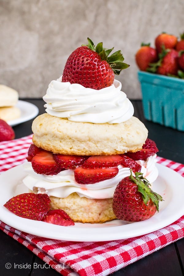 Homemade Strawberry Shortcake - layers of homemade shortcakes, fresh strawberries, and whipped cream makes an impressive dessert. Try this classic dessert recipe any time of year! #strawberry #shortcake #homemade #biscuits #summerdessert #recipe 