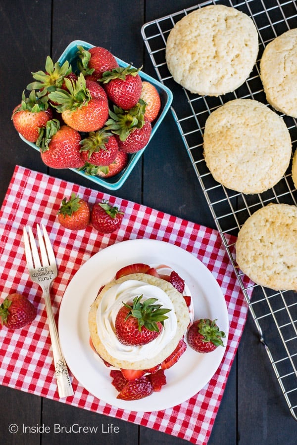 Homemade Strawberry Shortcake - sweet homemade biscuits layered with fresh strawberries and cream. This classic summer dessert is delicious any time of year! #strawberry #shortcake #homemade #biscuits #summerdessert #recipe 