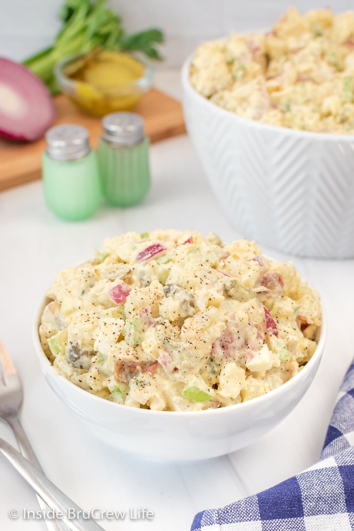 A white bowl filled with potato salad.