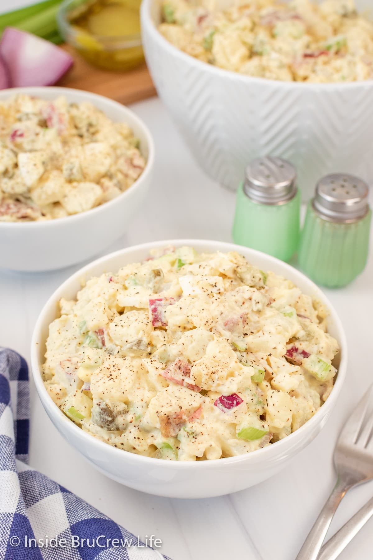 A white bowl filled with potato salad.