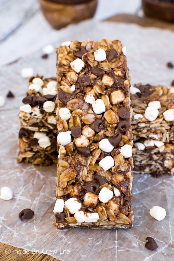 A close up picture of a nutella s'mores granola bar leaning up against a few other bars on a board