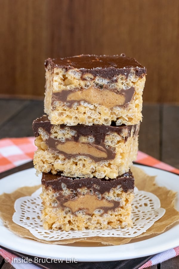 A white plate with a stack of three peanut butter cup rice krispie treats stacked on it