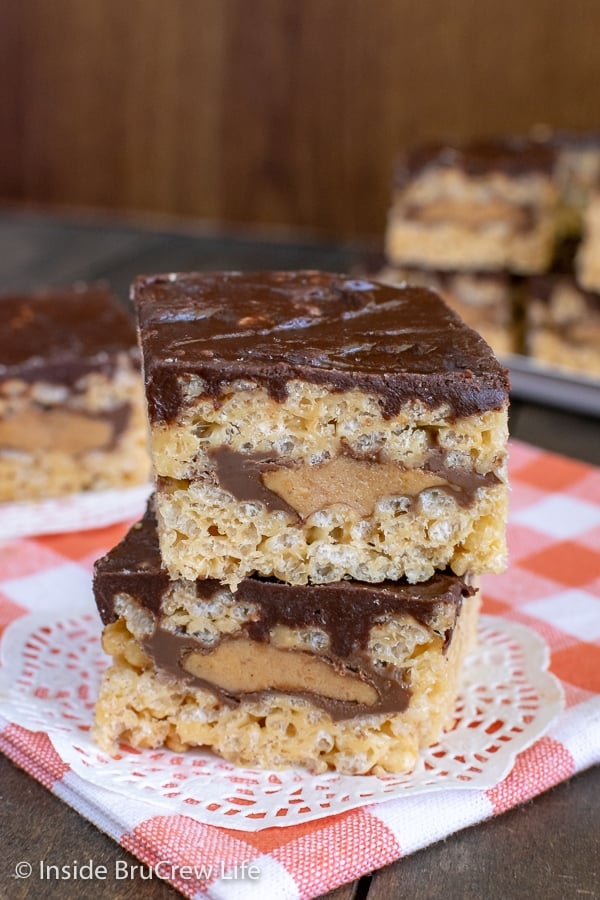 Two peanut butter cup rice krispie treats stacked on top of each other on an orange and white towel