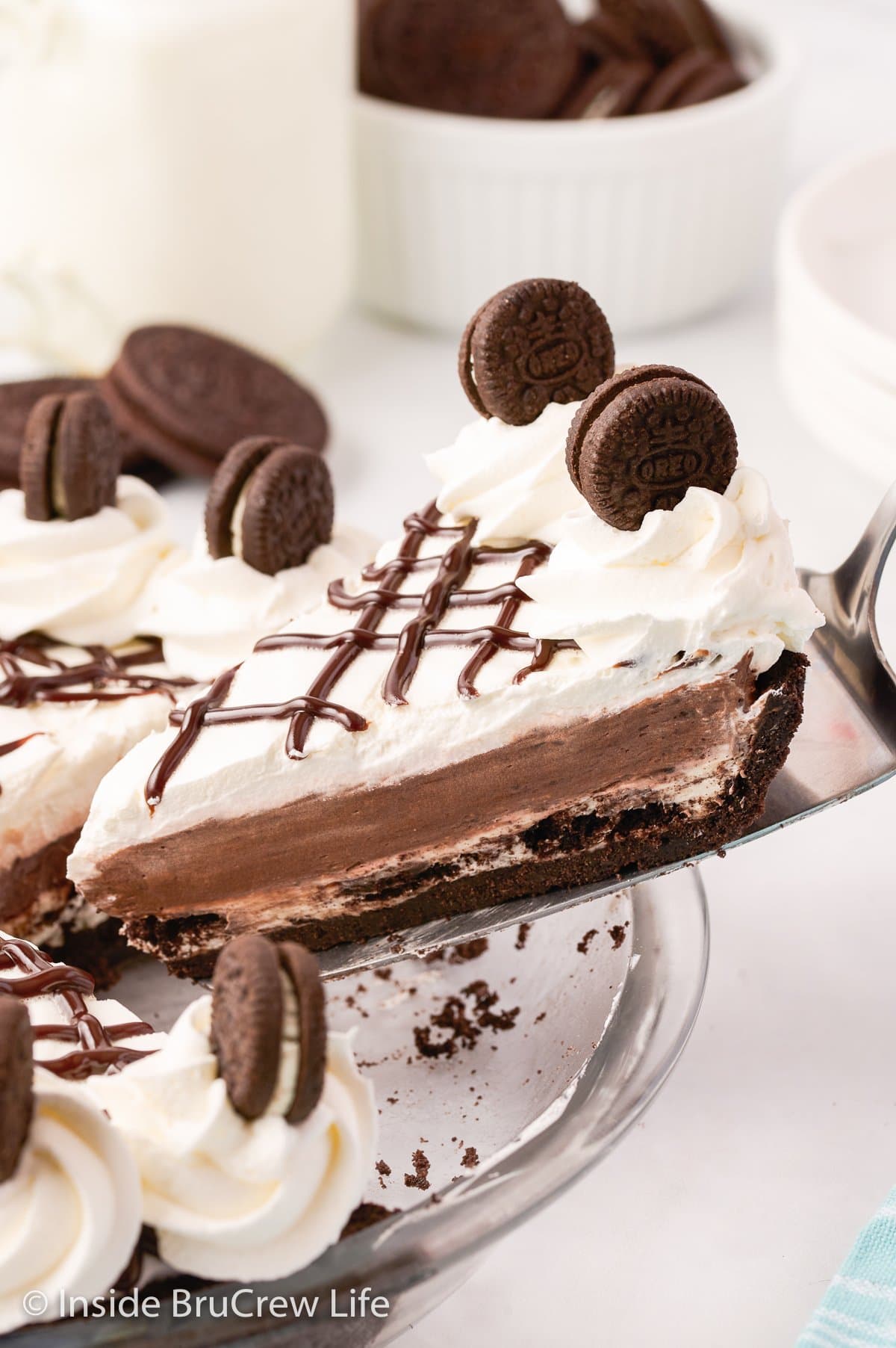 A slice of cookies and cream pie being lifted up out of the pie.