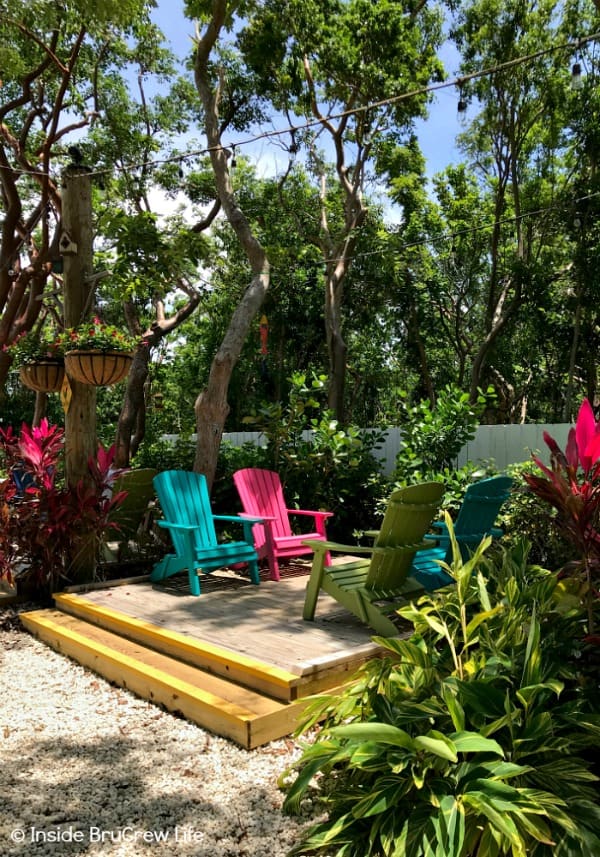 Adirondack chairs in the gardens at Blond Giraffe Key Lime Pie Factory.