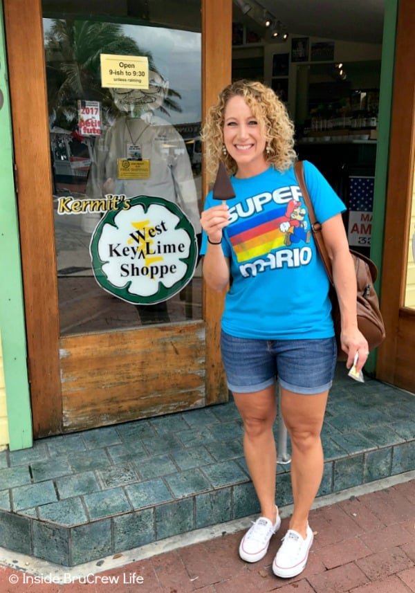 A tourist outside Kermit's Key Lime Shoppe in Key West holding a slice of pie. 