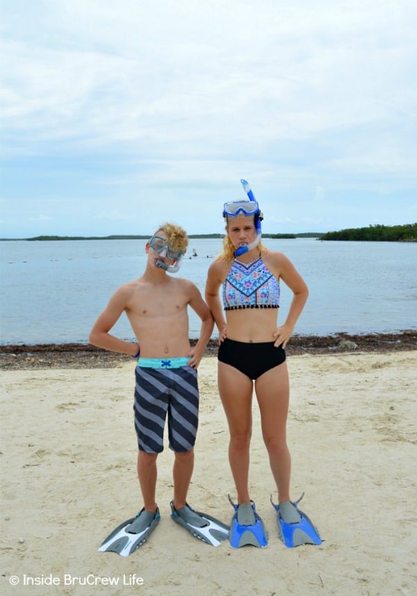 Two swimmers with snorkel gear on.