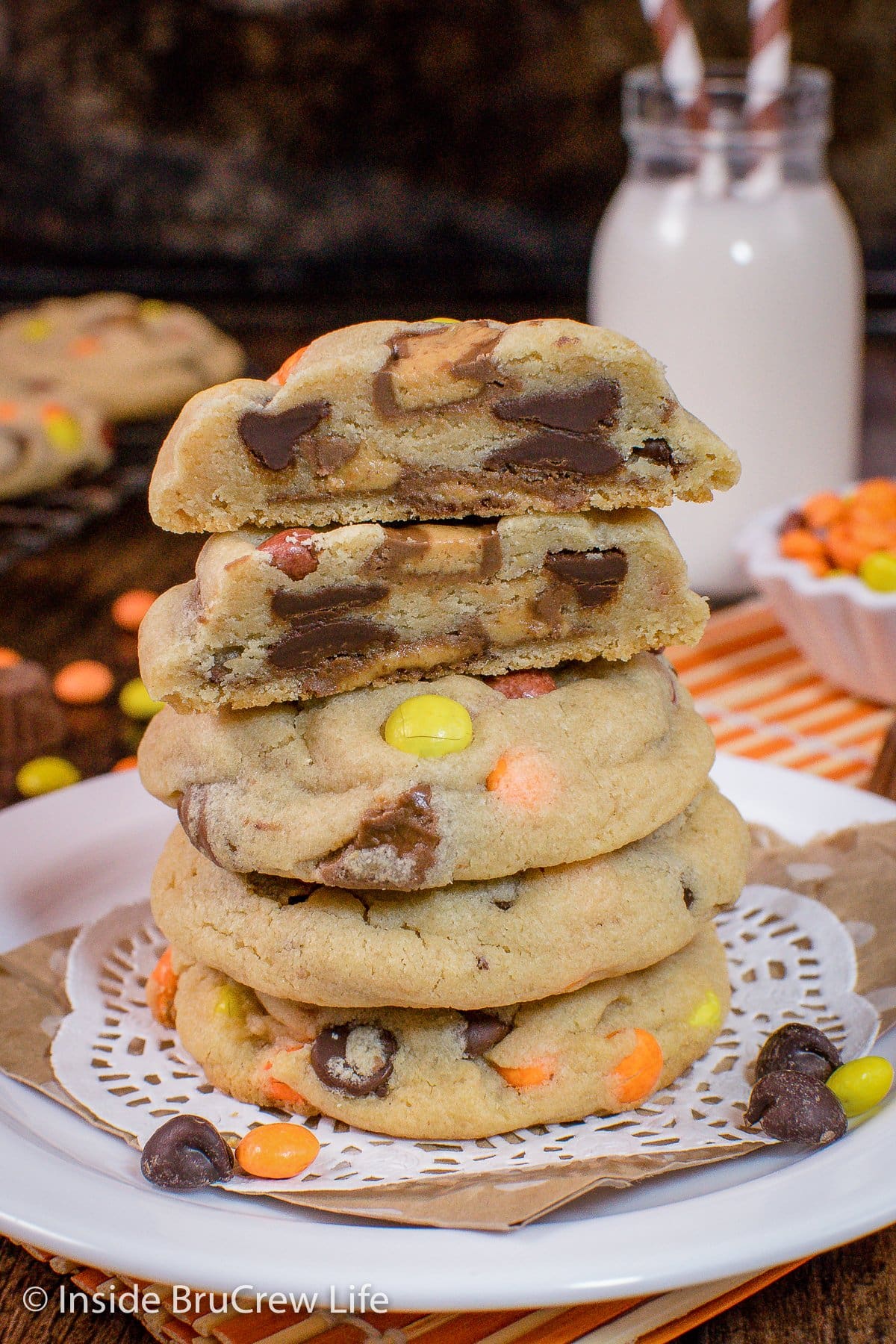 A white plate with a stack of peanut butter cookies on it.