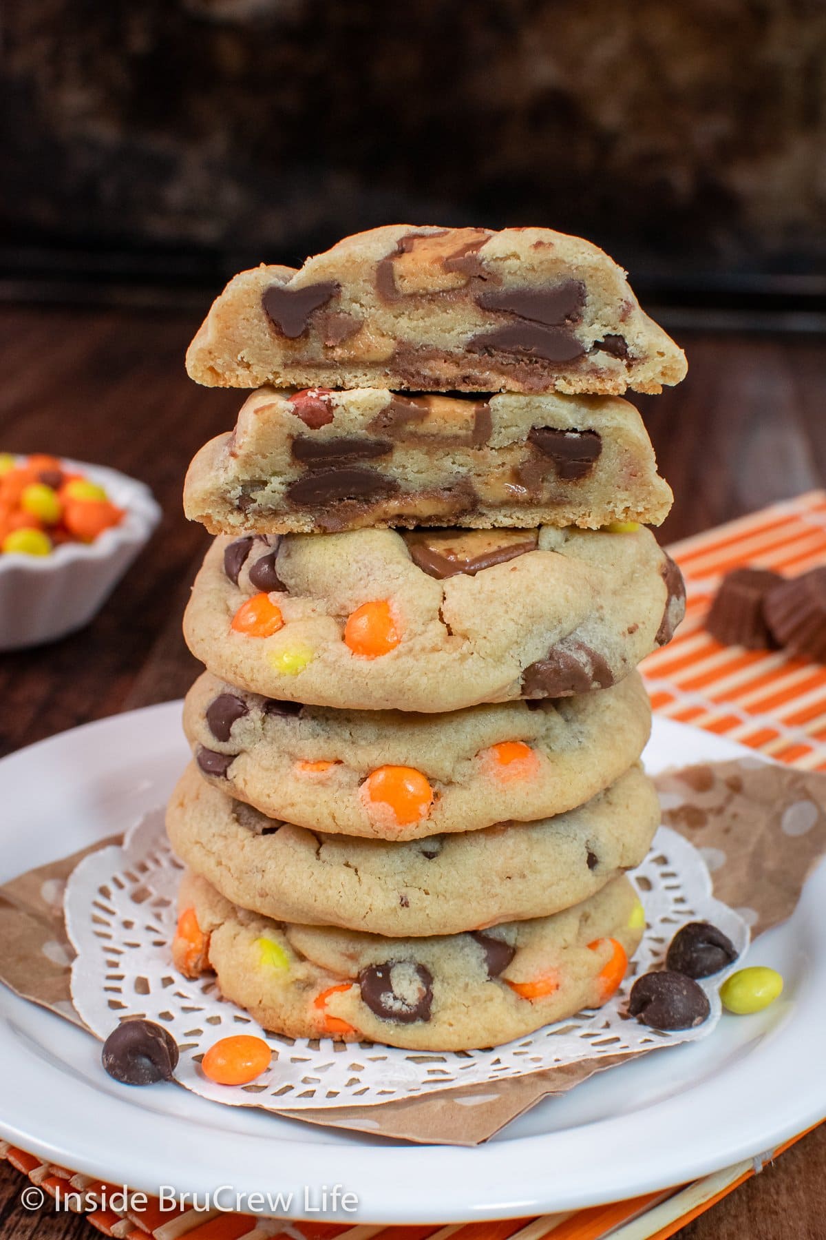 A tall stack of peanut butter cookies loaded with Reese's candies.