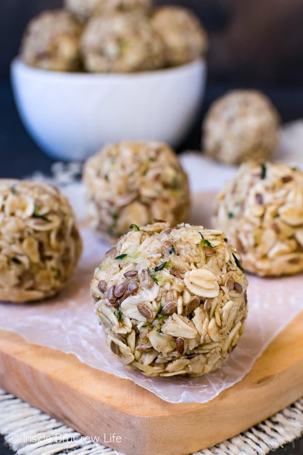 A wood tray with zucchini oatmeal bites sitting on it