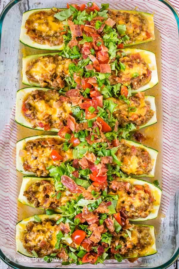 Overhead picture of a baking dish filled with baked cheeseburger stuffed zucchini.