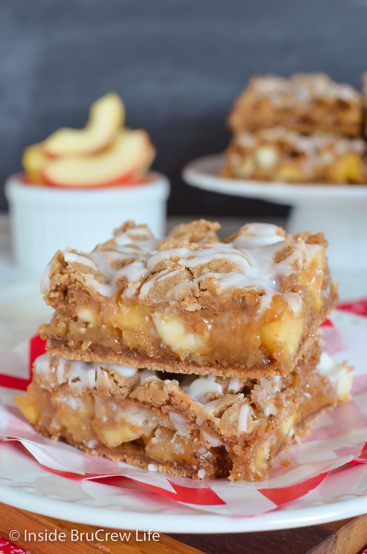 Two apple bars stacked on a white plate.