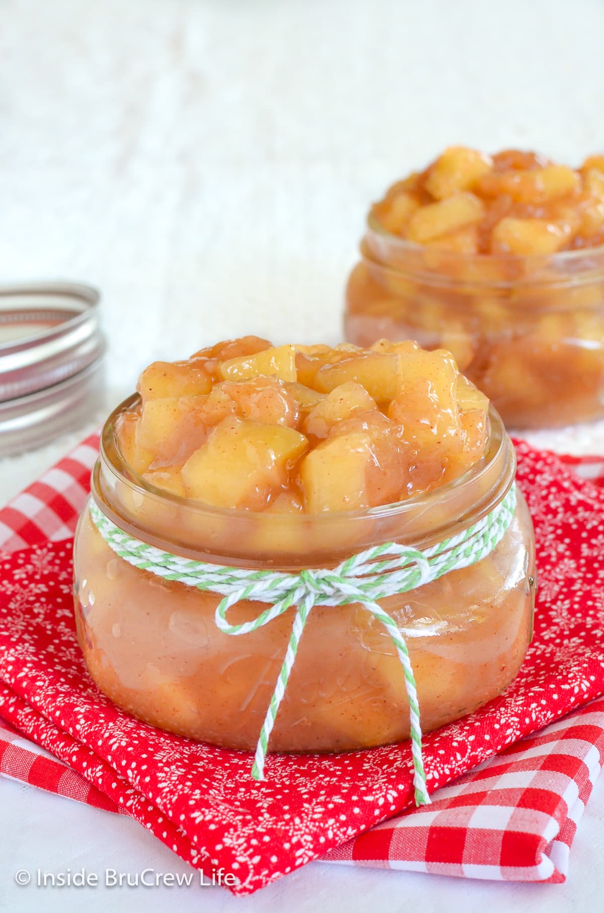 Two clear jars filled with apple filling.