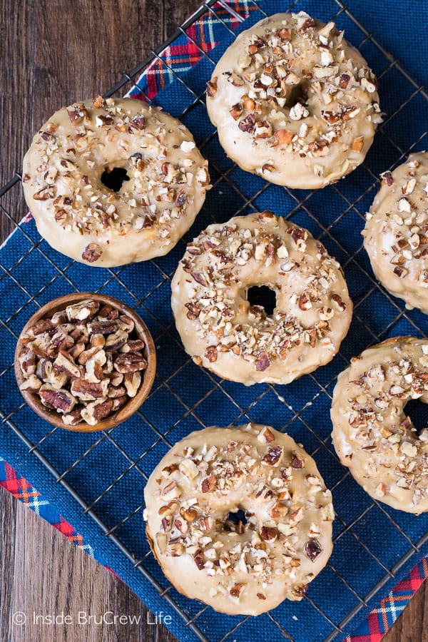 Apple Praline Donuts - soft baked donuts topped with a sweet praline glaze and pecans makes a delicious breakfast treat. Try this recipe on a cool fall day! #donuts #apple #pecans #praline #homemade #bakeddonuts #fall #recipes #breakfast #brunch #afterschoolsnack