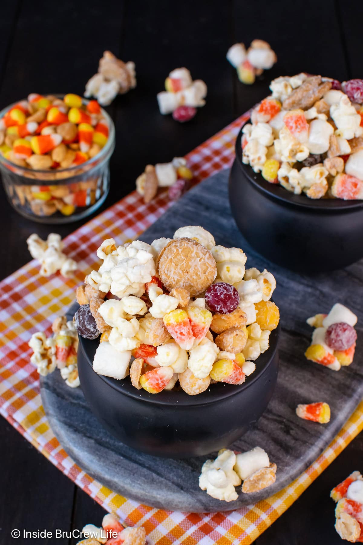 A fall snack mix in black bowls.