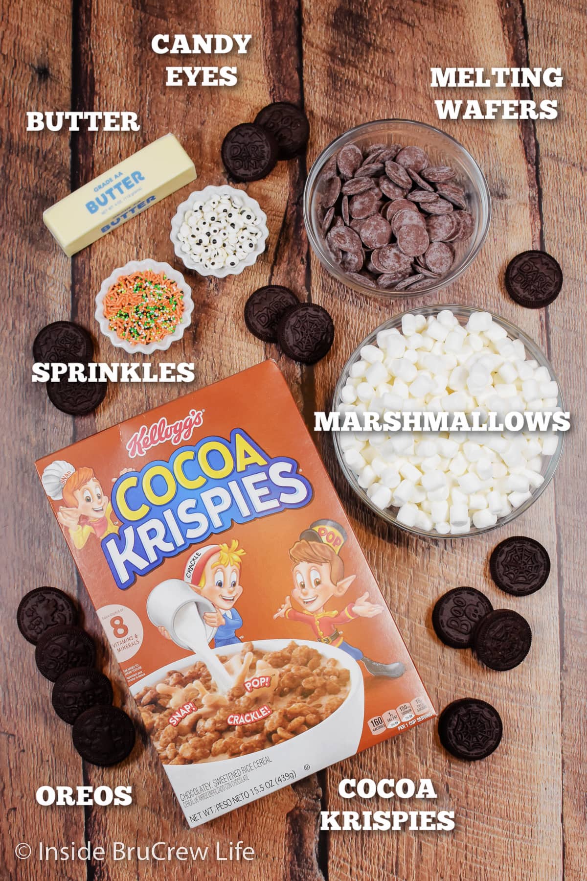 A board with bowls of ingredients to make rice krispie treats.