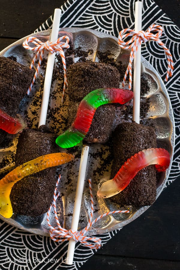 Dirt Marshmallow Pops - chocolate covered marshmallows become a fun dirt dessert when covered in Oreo cookie crumbs and gummy worms. Perfect no bake dessert for Halloween or school parties! #halloween #dirtdessert #marshmallowpops #chocolatecoveredmarshmallows #gummyworms #halloween #nobakedessert #chocolate #marshmallows