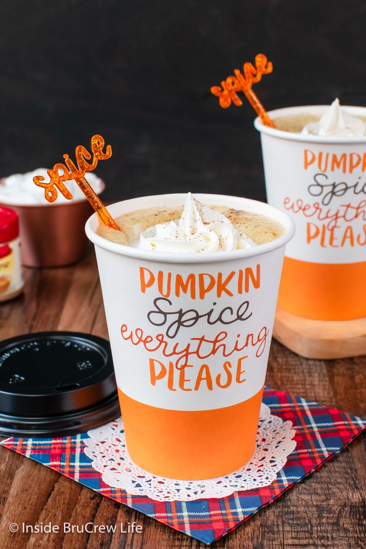 A paper cup filled with pumpkin coffee.