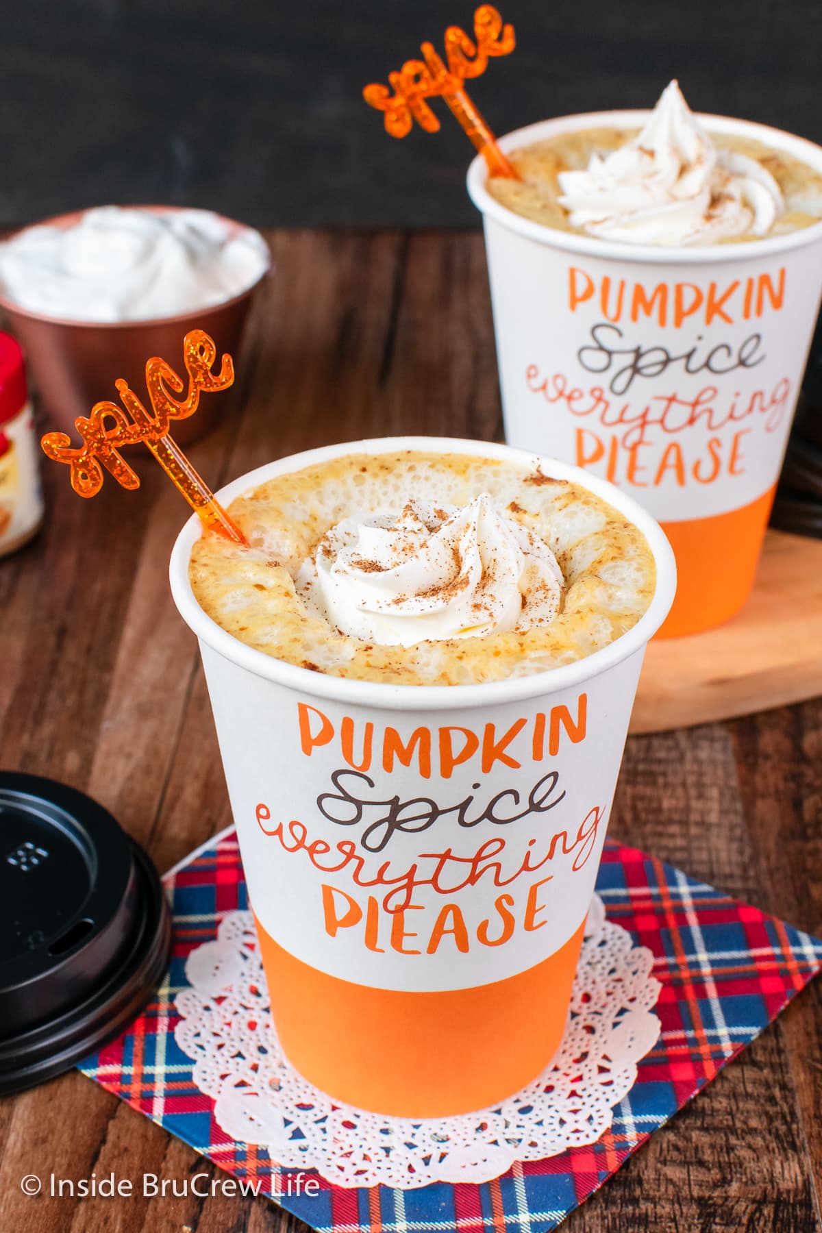 Two pumpkin coffees with whipped cream.