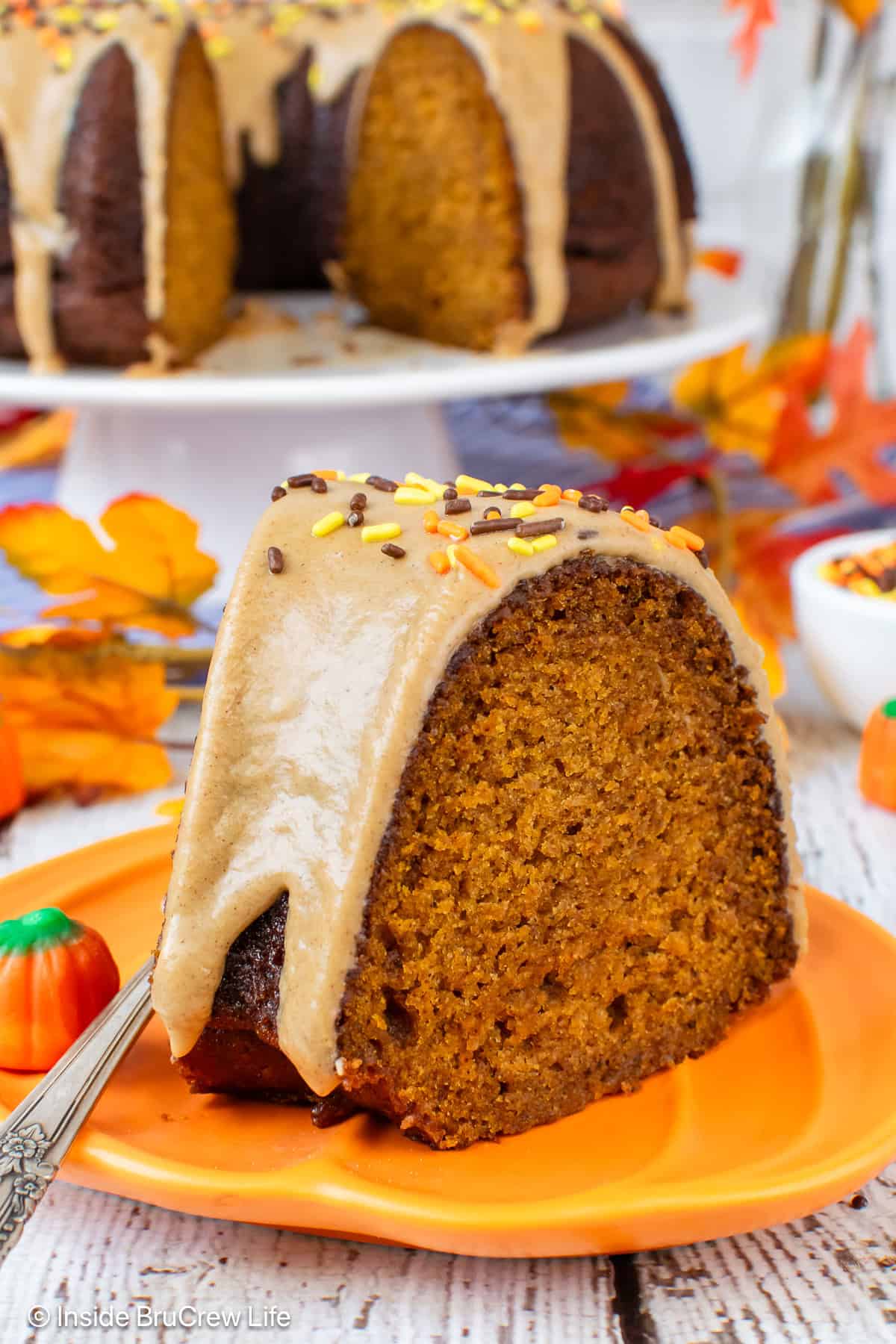 A slice of pumpkin bundt cake on an orange plate.