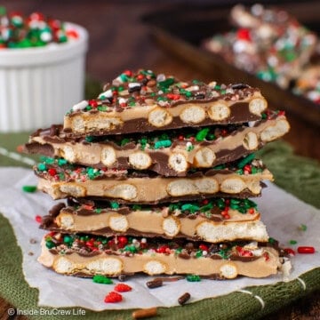 A stack of caramel chocolate pretzel bark on a sheet of parchment paper.