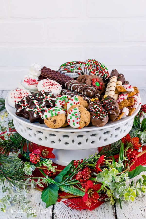 A cake plate full of Decorated Store Bought Cookies.