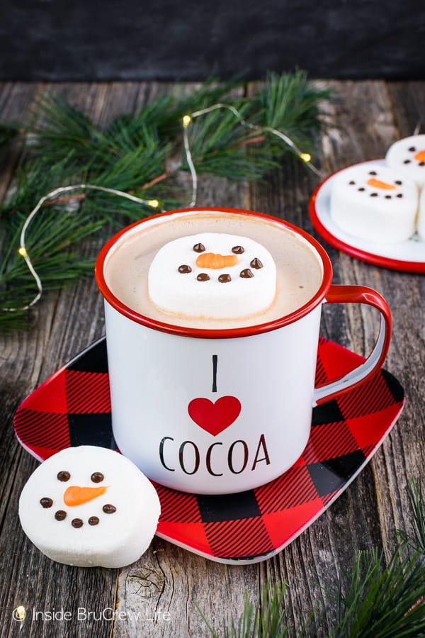 A cup of hot cocoa with a Floating Marshmallow Snowmen head in it.