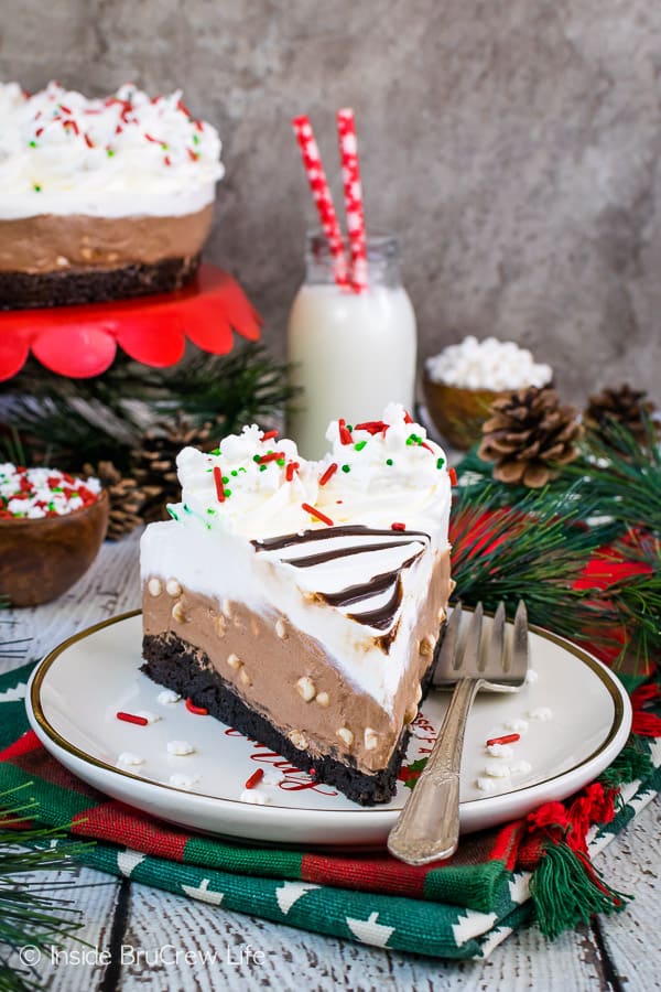 A white plate with a slice of hot cocoa cheesecake on it.