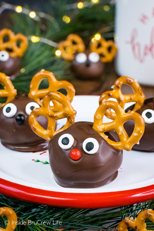 Three peanut butter balls with google eyes, a nose and pretzel ears so they look like Peanut Butter Reindeer. 