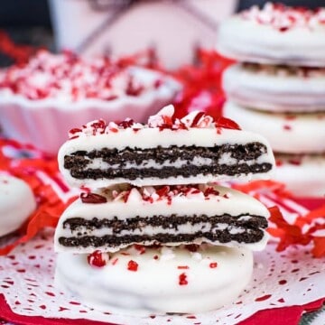Two peppermint Oreos dipped in white chocolate stacked on top of each other.