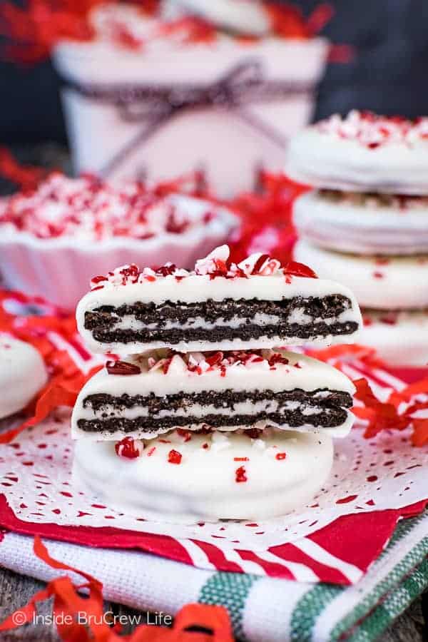 Two peppermint Oreo thins stacked on top of each other with one cut open to show the cookie layers.