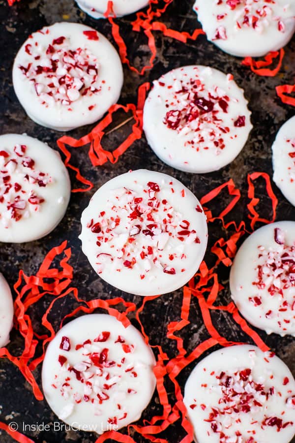 A metal tray with peppermint Oreos topped with candy bits on it.