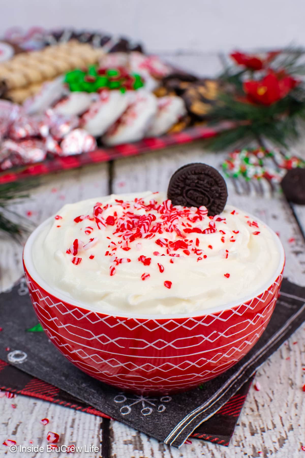 A red bowl filled with a creamy peppermint dip.