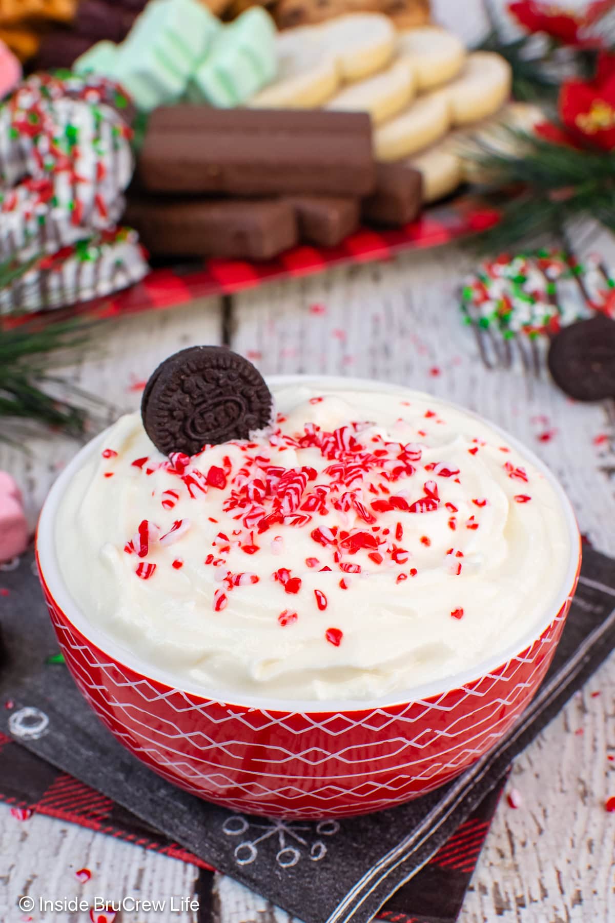 A bowl of peppermint dip on a white board.