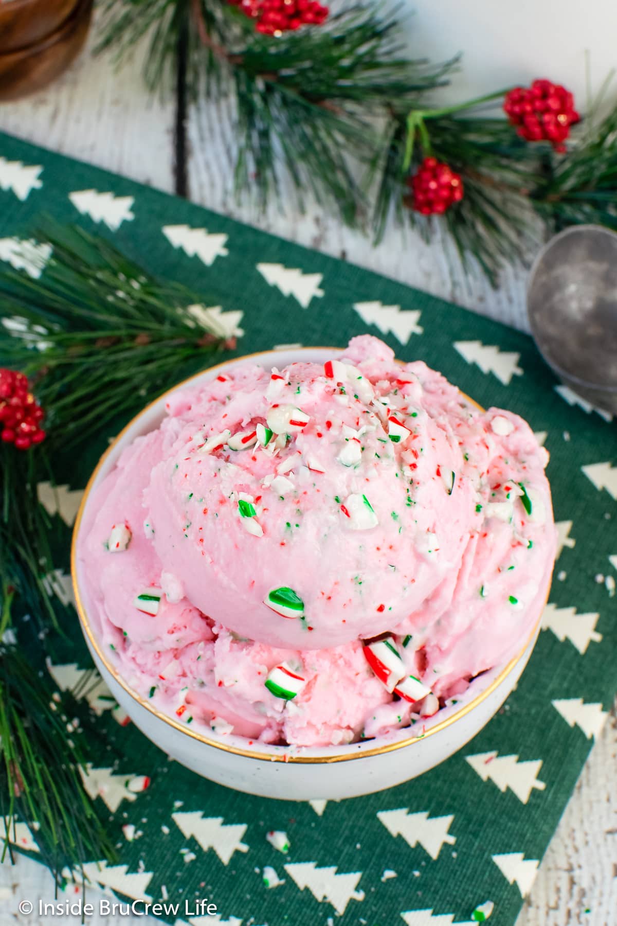Pink ice cream in a white bowl.