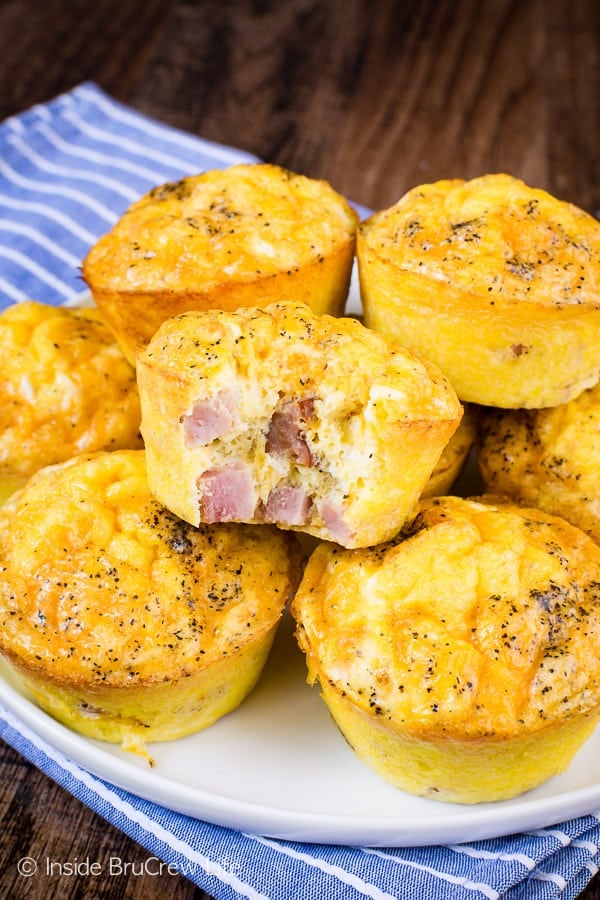 A stack of ham and cheese egg muffins on a white plate