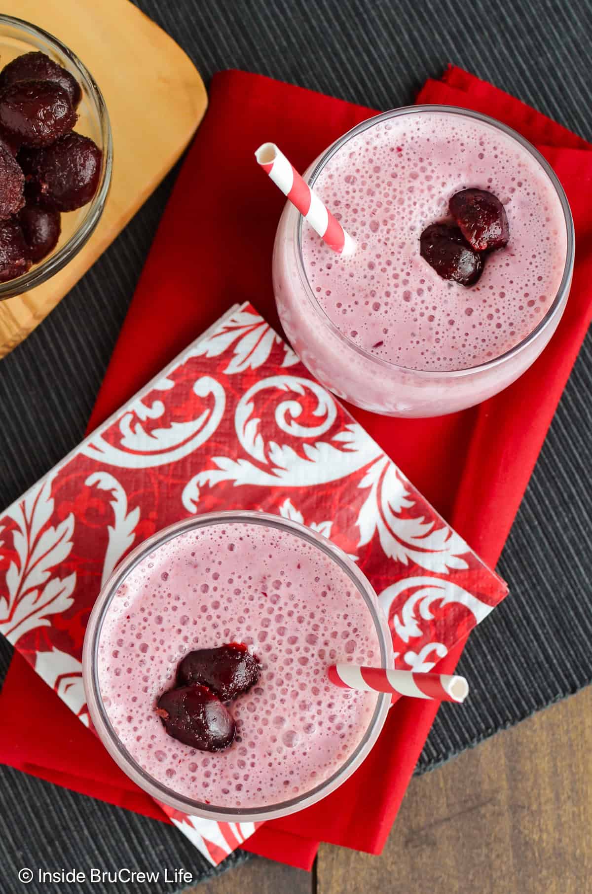 Overhead picture of two glasses filled with a cherry smoothie.