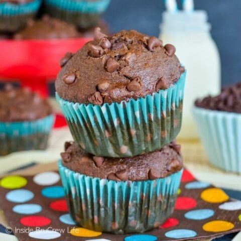 Two chocolate banana muffins stacked on top of each other.