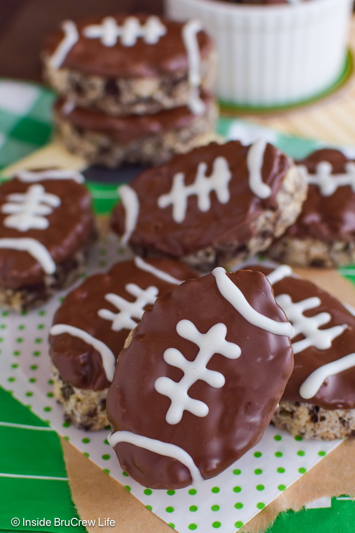 A stack of football shaped cereal treats on a board.