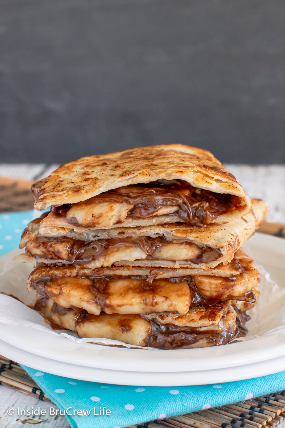 A stack of tortillas filled with chocolate and banana slices.