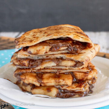 A stack of tortillas filled with chocolate and banana slices.