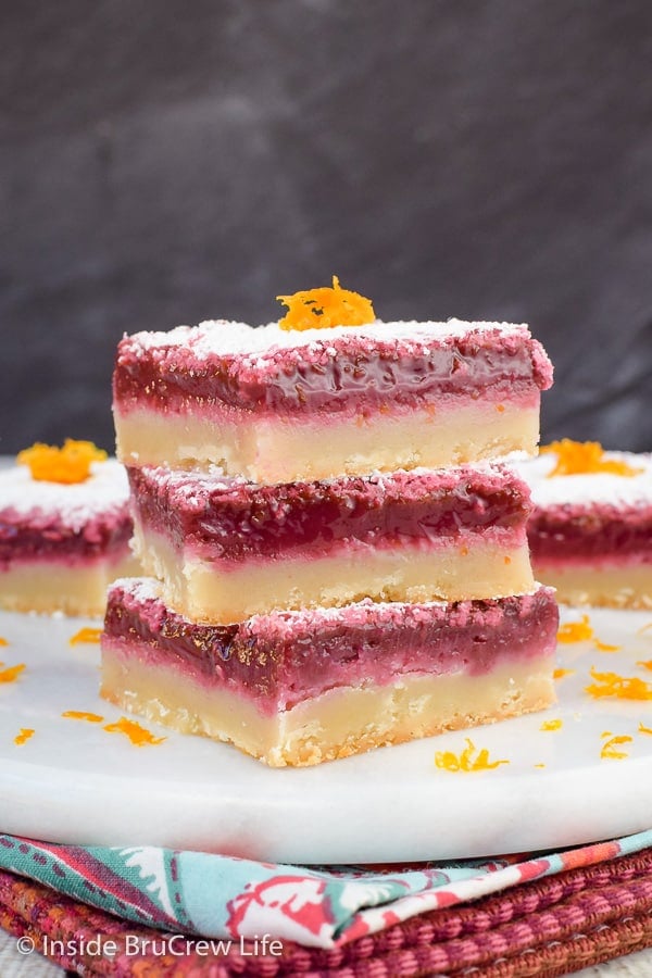 Three blood orange bars stacked on top of each other on a white tray.