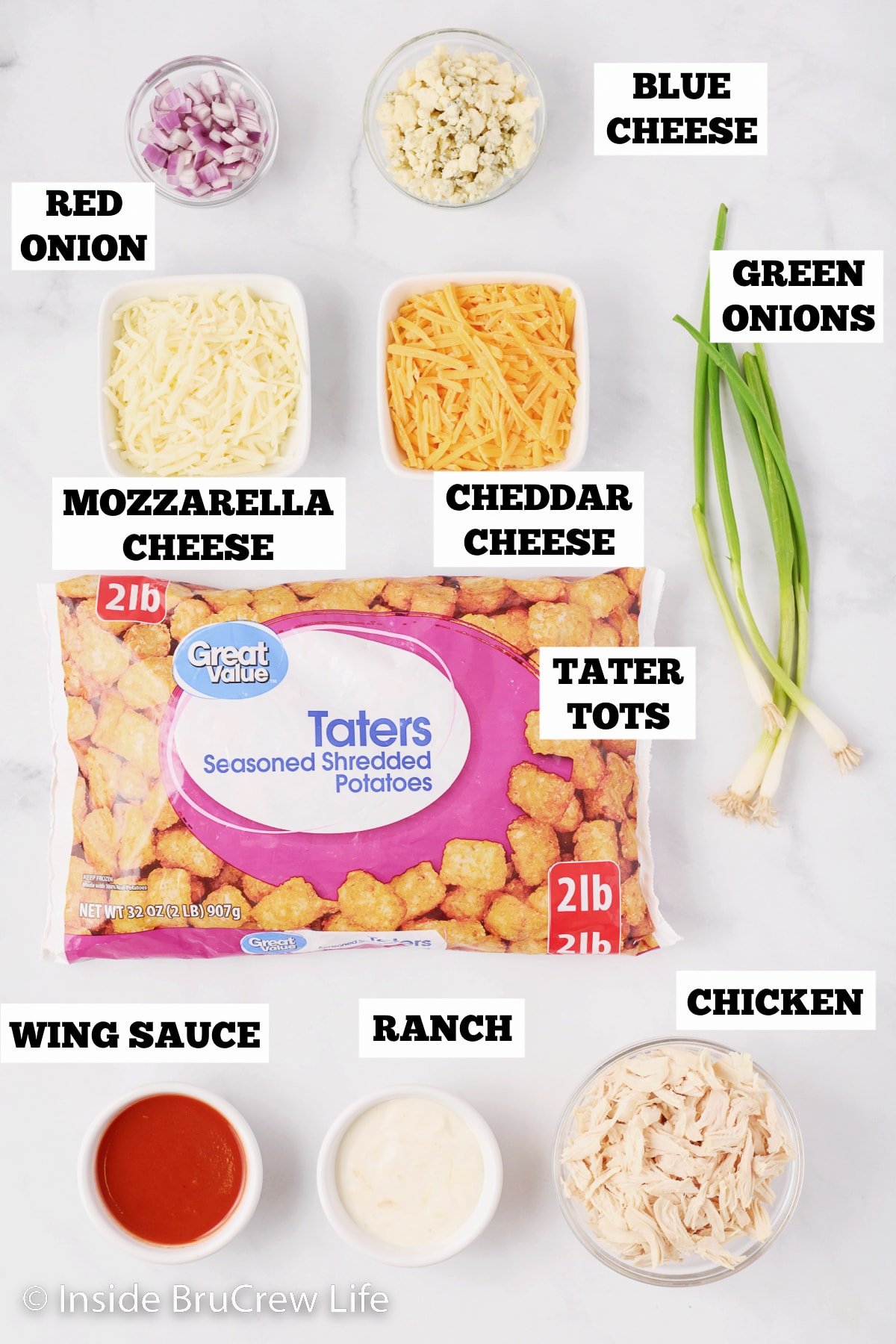 A white board with bowls of ingredients to make buffalo tots.