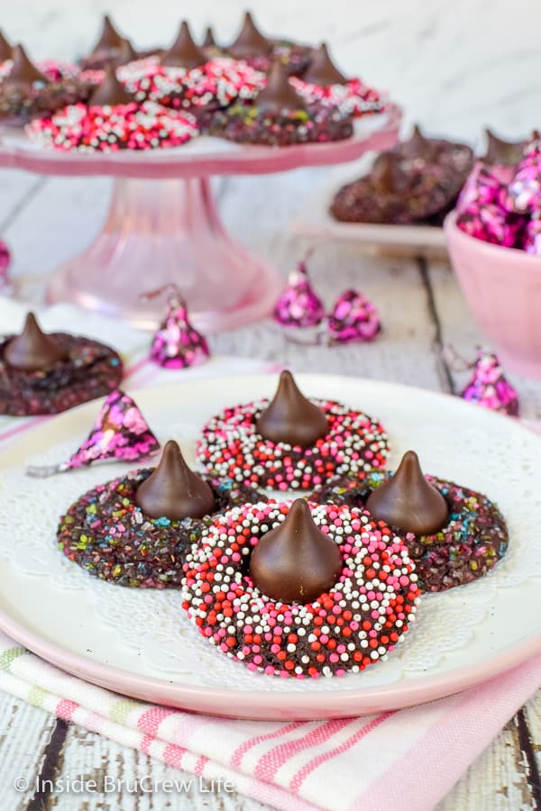 A plate of chocolate cookies covered in valentine sprinkles.