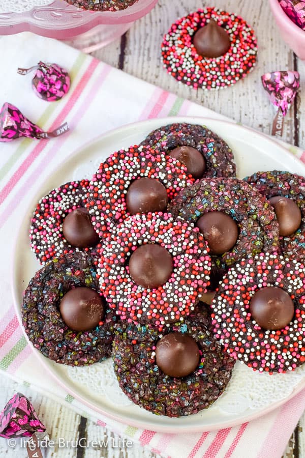An overhead picture of chocolate cookies covered in Valentine sprinkles.