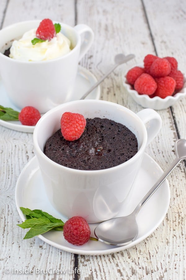 Two white cups with healthy chocolate lava cake in them.