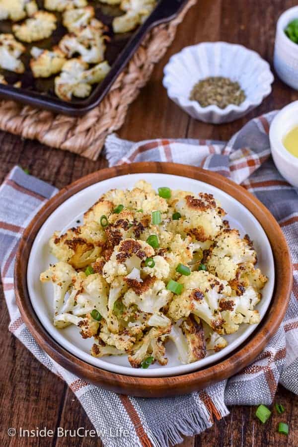 Oven Roasted Cauliflower - the crispy caramelized edges on this easy side dish will have you reaching for another scoop in a hurry. Great recipe to make for healthy dinners! #cauliflower #leanandgreen #healthy #roastedveggies #roastedcauliflower